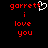 Red pixelated text 'garrett i love you' on black background with white heart symbol replacing the letter 't' in 'garrett'.