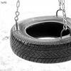 Black-and-white image of a tire swing suspended by metal chains against a light background.
