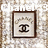 Pixelated static image of a framed document with a stylized 'CC' symbol centered inside the frame on a light background.