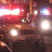 A blue background with red pixelated text and a small blurry image of a vehicle with lights on the left side.