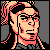 Pixelated static icon of a character with light skin, dark hair in a ponytail, and glasses against a gray background.