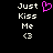 Pixelated text 'Just Kiss Me <3' appears twice on a black background with one instance featuring a pink heart symbol replacing the '<3'.