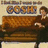A pixelated image shows a person seated at a brown piano with a light-colored background, featuring a partially visible text banner above the piano.