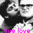 Pixelated grayscale image of a person with dark hair and a dark top, with bright pink text at the bottom reading 'tue love'.