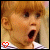 six identical static images showing a child with light brown hair and bangs, mouth open in surprise, wearing a striped shirt. Each image has a small red or black heart symbol in the top-left corner