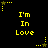 Yellow pixelated text 'I'm In Love' repeated across black background with scattered star and dot patterns.
