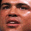 Pixelated close-up of a human face showing eyes, nose, mouth with visible teeth and lips in warm tones.