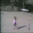 A pixelated static image shows a stylized figure with purple and white vertical elements against a light gray background, partially obscured by dark shapes.