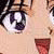 A close-up of a stylized character's face with large expressive eyes, a small nose, and a mouth open in a wide smile showing a tongue.