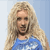 Static pixelated image of a person with long blonde hair wearing a blue top against a light blue background.