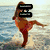 A pixelated figure in a red dress performs a high kick on a beach, with a green star-shaped background and a white cloth with an orange stripe in subsequent frames.