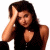 A woman with long dark hair in a black sleeveless top poses against white background, hand raised to forehead; green text reads Original Icons .com on dark green