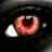 A pixelated close-up of a red eye with white highlights on the left, next to red text reading 'Life is pain.' on black background.