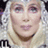A static image of a person with blonde hair and light skin, wearing a silver headpiece with intricate patterns.