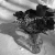 Grayscale pixelated image of a dark, irregularly shaped object with internal lighter areas against a gradient background.