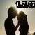 Two silhouetted figures in formal attire kiss under a digital timestamp display.