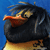 Pixelated close-up of a bird with black body, orange beak, and yellow underbelly against blue background.