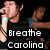 A pixelated animation of a person in a black shirt holding a microphone, with text reading 'Breathe Carolina' below.