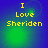 Yellow pixelated text "I Love Sheriden" on a blue-green gradient background with subtle circular light effects.