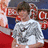 Pixelated static image of a person in white and gray clothing with red and blue background elements.
