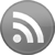 Gray circular icon with white RSS symbol featuring two curved lines and a circle on a flat background.
