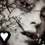Pixelated grayscale image of a stylized face with closed eyes and a heart symbol in the bottom-left corner.