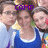 Three people in a group pose with one person wearing a blue sleeveless top, another in light-colored clothing, and the third partially visible; purple text 'CAMP' overlaid at the top.