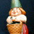 Pixelated garden gnome in a wicker basket with green conical hat, white shirt, red apron; right side shows "OriginalIcons.com" text on dark green background.