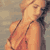 Pixelated static image of a person in a bikini top with visible straps, set against a muted background.