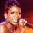 A pixelated contact sheet showing two frames of an animated icon featuring a person singing into a microphone on the left and green text reading "Original Icons .com" on the right against a dark background.