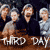 Static pixelated image of four figures with text "THRD" and "DAY" on a brown surface against dark background.