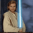Pixelated static image of a character in light-colored robes holding a blue lightsaber against a dark background.