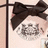 Pixelated image of a character with dark hair tied in large bows, wearing a light-colored top against a pale background.