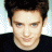 A 48x48 pixel buddy icon featuring a split composition with a person on the left and green text on the right against a dark background.