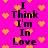 A static image with a bright pink background filled with orange pixelated hearts and repeated black text reading "I Think I'm In Love" in two vertical