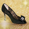 Black high-heeled shoe with lace detailing and a bow on the toe, set against a golden textured background.