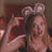 A pixelated image of a person wearing mouse ears, making a hand gesture, with blue background and pixelated text.