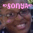 A pixelated image of a smiling person with glasses, featuring pink text overlays in different positions across four