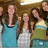Group of people with long brown hair standing closely together in a pixelated image.
