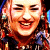 Pixelated image of a smiling person with long brown hair on left, split background with cyan and pink sections containing bold black text "I love the 80's".