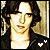 Animated contact sheet of a person with dark wavy hair wearing a black jacket over a white shirt, showing three frame variations with heart symbols changing from white to gold.