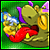 Animated pixel art of a green dragon-like creature with purple horns, red tongue, and yellow accents holding a golden object emitting blue sparks.