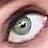 A pixelated close-up of a human eye with dark brown eyelashes and light skin tones surrounding the iris.