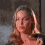 A woman with long light brown hair in a black top appears in four showing slight head and hand movements