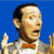 Pixelated static image of a cartoon character with dark hair, light skin, and an orange bow tie against a solid blue background.