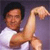 Pixelated image of a person in a white shirt flexing a bicep against a purple background.