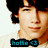Pixelated close-up of a person with dark curly hair and light skin wearing a black bow tie, with teal text below.
