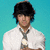Pixelated image of a person with dark hair wearing a white shirt and dark tie against a solid teal background.