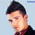 Static pixelated icon of a person's head and shoulders with dark hair, light skin tone, and red-accented clothing against a pale blue background.