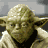 Yoda character in beige robe with green lightsaber, shown across where the lightsaber appears and disappears